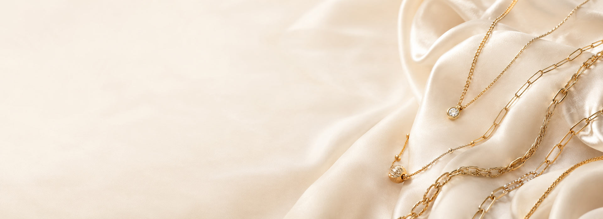 Fine gold jewellery on ivory silk